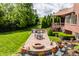 Entertainer's backyard with firepit, outdoor kitchen, and lush landscaping at 10541 Titan Run, Carmel, IN 46032
