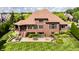 Aerial view of the backyard with patio, fire pit, outdoor dining, lush lawn and mature trees at 10541 Titan Run, Carmel, IN 46032