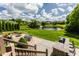 Backyard with fire pit, bar, outdoor dining area, and lush landscaping at 10541 Titan Run, Carmel, IN 46032