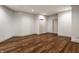 Spacious basement area with hardwood flooring and neutral walls, offering versatility at 10541 Titan Run, Carmel, IN 46032