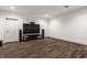 Entertainment space with mounted TV, speaker system, and wood-look tile floors at 10541 Titan Run, Carmel, IN 46032