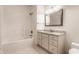 Bathroom featuring a tub-shower combo with a white tile surround and a granite countertop vanity at 10541 Titan Run, Carmel, IN 46032