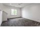 Expansive bedroom with gray carpet, ceiling fan, recessed lights, and large window providing natural light at 10541 Titan Run, Carmel, IN 46032