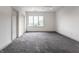 Bedroom boasting plush gray carpeting, a large window, and neutral walls at 10541 Titan Run, Carmel, IN 46032
