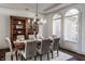 Dining room showcasing hardwood floors, a built-in cabinet, and traditional decor at 10541 Titan Run, Carmel, IN 46032