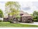 Charming two-story brick home with a meticulously landscaped front yard and well manicured lawn at 10541 Titan Run, Carmel, IN 46032
