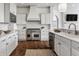 Stylish kitchen with stainless steel appliances, white cabinetry, and a marble backsplash at 10541 Titan Run, Carmel, IN 46032