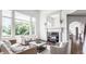 Inviting living room with fireplace, hardwood floors, large windows, and comfortable seating at 10541 Titan Run, Carmel, IN 46032