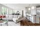 Open-concept living room with hardwood floors and a seamless flow to the kitchen and dining areas at 10541 Titan Run, Carmel, IN 46032