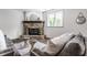 Living room features a stone fireplace, glass table, gray couches, and a large window at 10541 Titan Run, Carmel, IN 46032
