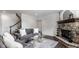 Living room features a gray couch, area rug, glass table, and a stone fireplace at 10541 Titan Run, Carmel, IN 46032