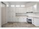 Bright mudroom featuring abundant white cabinetry, countertop space, and a convenient built-in desk area at 10541 Titan Run, Carmel, IN 46032