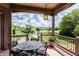 View from covered patio overlooking backyard pond and lush lawn at 10541 Titan Run, Carmel, IN 46032