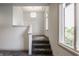 Carpeted staircase landing with an eye-catching modern light fixture and large arched window at 10541 Titan Run, Carmel, IN 46032