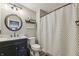 Bathroom featuring a toilet, black and white shower curtain, sink, mirror, and decor at 10887 Gresham Pl, Noblesville, IN 46060
