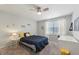 Bright bedroom featuring neutral walls, carpeted floor, ceiling fan, and window with natural light at 10887 Gresham Pl, Noblesville, IN 46060