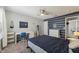 Stylish bedroom with striped wall, carpeted floor, fan, writing desk, and a comfortable bed at 10887 Gresham Pl, Noblesville, IN 46060