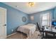 Cozy bedroom with blue walls, featuring a carpeted floor, decorative wall art, and a wooden desk at 10887 Gresham Pl, Noblesville, IN 46060