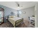 Charming bedroom featuring a bed with yellow floral bedding, a desk, and a diamond pattern accent wall at 10887 Gresham Pl, Noblesville, IN 46060