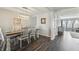 The dining room has stylish lighting, hardwood floors and an inviting table set for an elegant meal at 10887 Gresham Pl, Noblesville, IN 46060