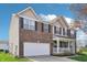 Two-story brick home featuring a two-car garage and inviting front porch at 10887 Gresham Pl, Noblesville, IN 46060