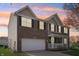 Two-story brick home featuring a two-car garage and inviting front porch at 10887 Gresham Pl, Noblesville, IN 46060