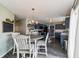 Eat in Kitchen with a round wood table and white chairs, with a view of the kitchen and black appliances at 10887 Gresham Pl, Noblesville, IN 46060