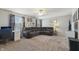 Large living room featuring a corner sofa, fan with lights, television, and a writing desk at 10887 Gresham Pl, Noblesville, IN 46060