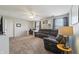 Spacious living room with a large sofa, a desk, and a ceiling fan with lighting at 10887 Gresham Pl, Noblesville, IN 46060