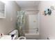 Small bathroom with a tub and shower combination, white vanity, and neutral walls at 1142 Sharon Ave, Indianapolis, IN 46222
