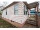 Exterior view of compact home shows windows, siding, trim and access to front porch at 1142 Sharon Ave, Indianapolis, IN 46222