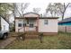 Charming single story home features covered front porch, side driveway, and compact front yard at 1142 Sharon Ave, Indianapolis, IN 46222