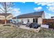 Backyard featuring a stone patio with furniture, a grill, and the exterior of the home at 12689 Sovereign Ln, Fishers, IN 46038