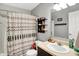 Bathroom featuring a shower with patterned curtain, a vanity with sink, and gray walls at 12689 Sovereign Ln, Fishers, IN 46038