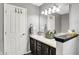 Bathroom featuring double vanity sinks, white cabinets, and vanity mirror at 12689 Sovereign Ln, Fishers, IN 46038