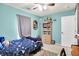 Bedroom with bright walls, bed with rocketship sheets and a bookshelf with toys and books at 12689 Sovereign Ln, Fishers, IN 46038