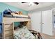 bedroom featuring a bunk bed with drawers and a closet with white doors at 12689 Sovereign Ln, Fishers, IN 46038