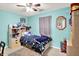bedroom with bright walls, bed with rocketship sheets and a bookshelf with toys and books at 12689 Sovereign Ln, Fishers, IN 46038