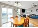 Bright dining room with wood table, hardwood floors, and a view of the backyard at 12689 Sovereign Ln, Fishers, IN 46038
