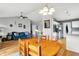 Open-concept dining room and living area with wood floors, seating and a view of kitchen at 12689 Sovereign Ln, Fishers, IN 46038