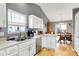 Open kitchen featuring stainless steel appliances, white cabinets, and an adjacent dining area at 12689 Sovereign Ln, Fishers, IN 46038