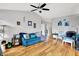 Bright living room featuring wood floors, a ceiling fan, and comfortable seating at 12689 Sovereign Ln, Fishers, IN 46038