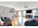 Open-concept living room and dining area featuring hardwood floors and modern decor at 12689 Sovereign Ln, Fishers, IN 46038