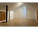 Attic with wood-look floors and a door at the far end at 1310 N Lasalle St, Indianapolis, IN 46201