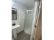 Bathroom with a white vanity sink and walk-in corner shower with glass door at 1310 N Lasalle St, Indianapolis, IN 46201
