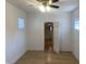 Clean bedroom with an entry to an attic bathroom, great light, and wood-look floors at 1310 N Lasalle St, Indianapolis, IN 46201