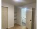 Neutral bedroom featuring a closet, wood-look flooring, and door leading to bathroom at 1310 N Lasalle St, Indianapolis, IN 46201