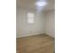 A bright room with window and clean wood-look floors at 1310 N Lasalle St, Indianapolis, IN 46201