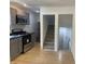 Modern kitchen featuring updated appliances, light gray cabinetry, and a functional layout with staircase access at 1310 N Lasalle St, Indianapolis, IN 46201