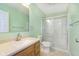 Bathroom featuring a vanity with white sink, toilet, and glass-enclosed shower at 1325 E 47Th St, Anderson, IN 46013